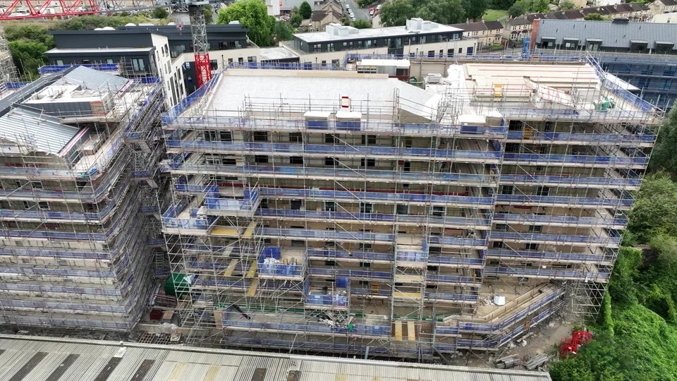 Scaffolded construction buildings with roof decks viewed from above