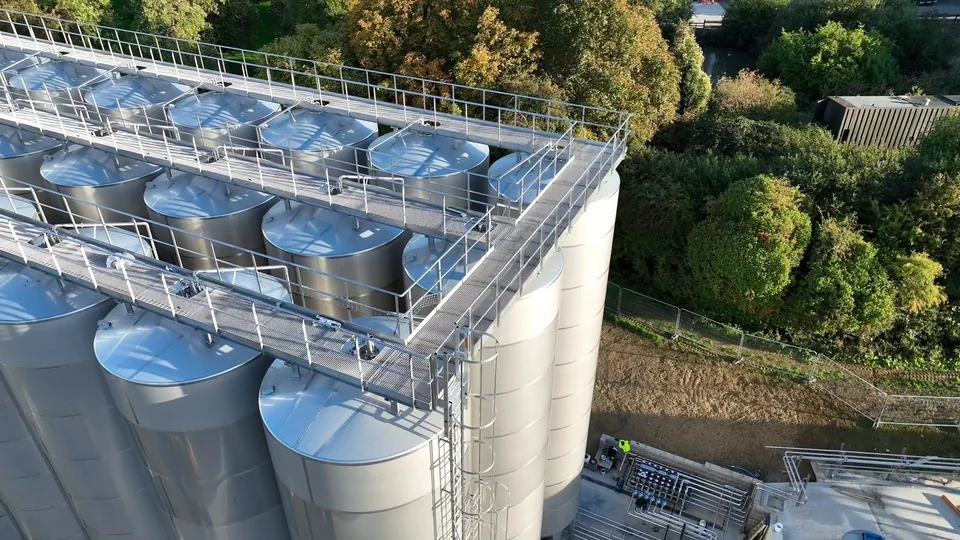 Aerial view of industrial silos with roof structures and walkways