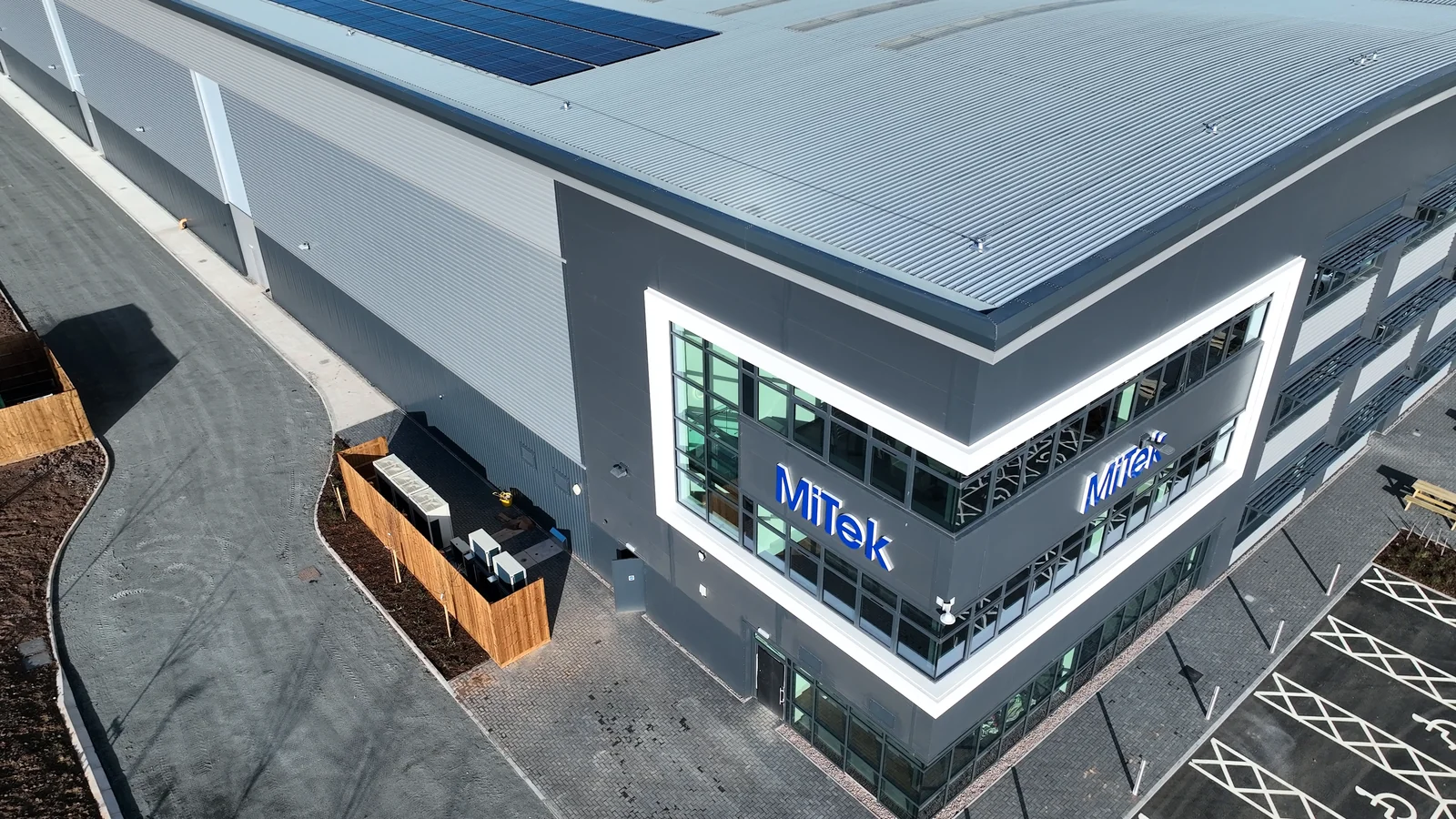 Oblique aerial view of a commercial building roof and elevations