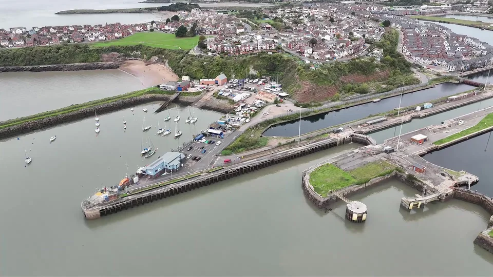 Aerial view of a dock basin, harbour entrance and surrounding waterfront