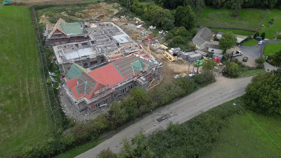Property construction site beside a road and open fields