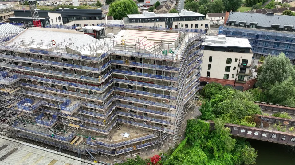Aerial view of a multi storey construction site beside surrounding buildings
